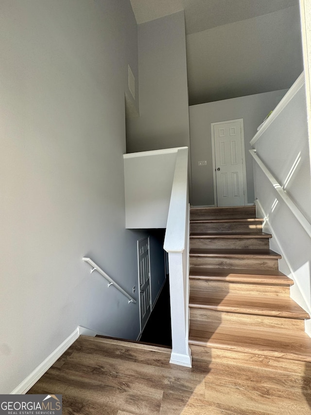 stairway featuring hardwood / wood-style floors