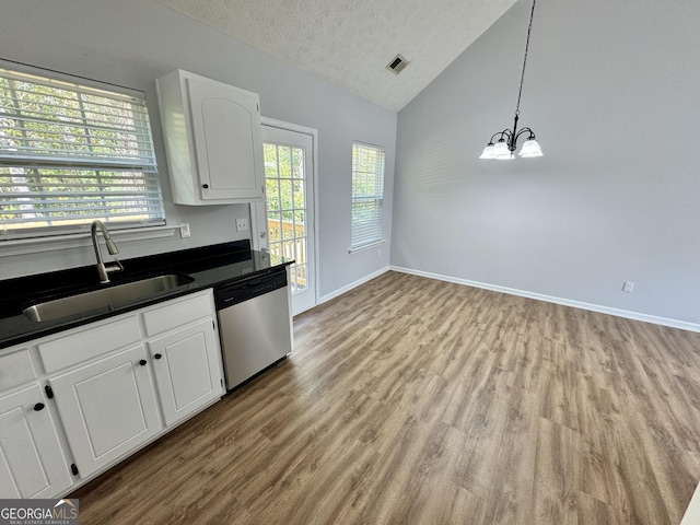 kitchen with dishwasher, white cabinets, sink, light wood-type flooring, and decorative light fixtures