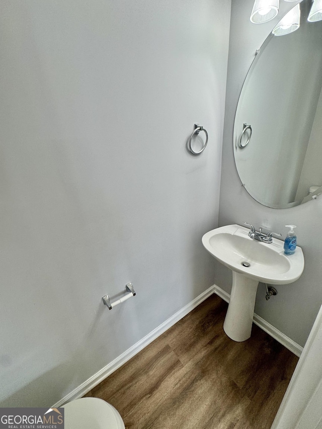 bathroom with hardwood / wood-style flooring