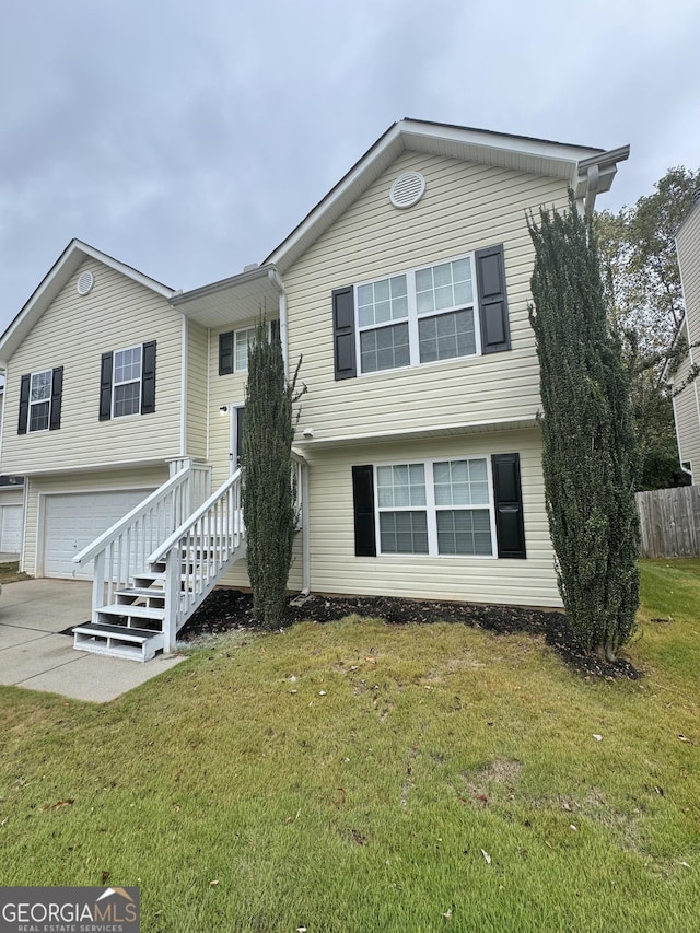 view of front of home featuring a garage and a front lawn