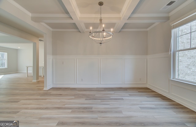 unfurnished dining area with beamed ceiling, an inviting chandelier, coffered ceiling, and light hardwood / wood-style floors