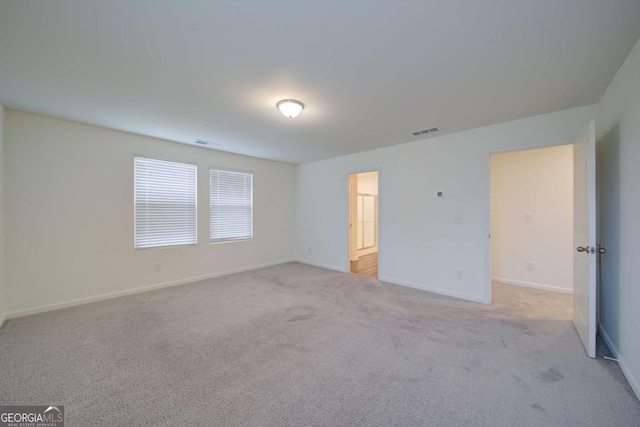 unfurnished room with light carpet