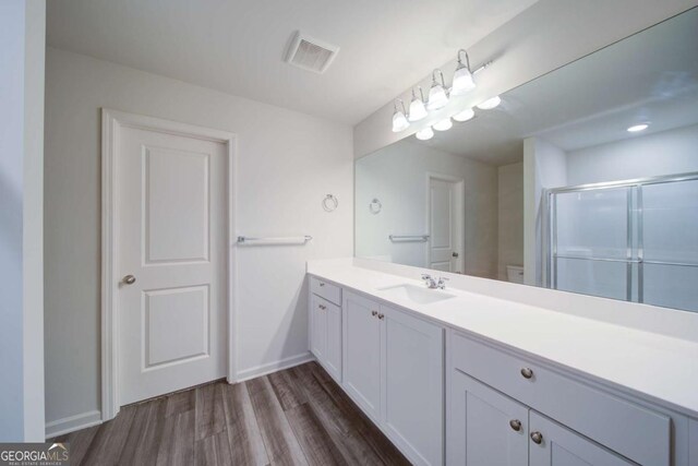 full bathroom featuring vanity,  shower combination, hardwood / wood-style flooring, and toilet