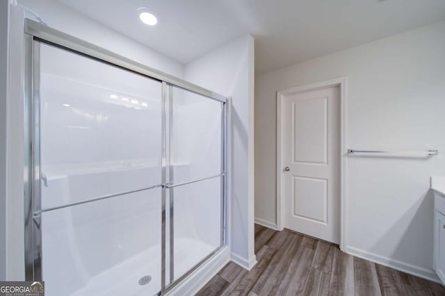 bathroom with vanity, hardwood / wood-style flooring, and an enclosed shower