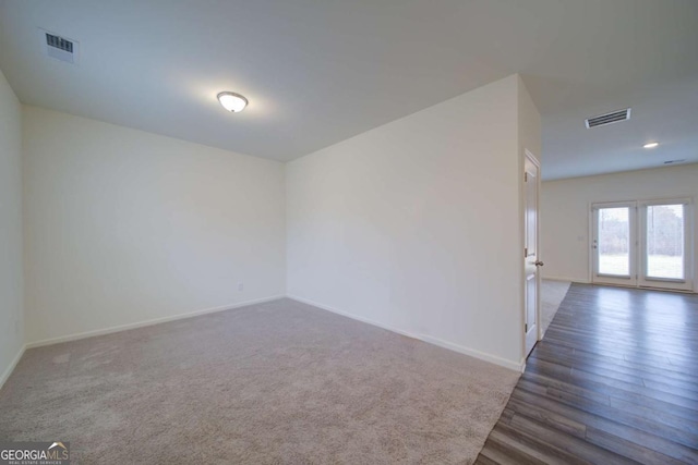 unfurnished room featuring dark wood-type flooring