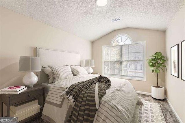 bedroom featuring carpet flooring, a textured ceiling, and vaulted ceiling