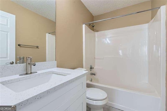 full bathroom with toilet, vanity, a textured ceiling, and bathtub / shower combination