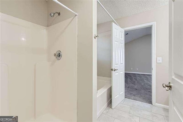 bathroom with tile patterned flooring and a textured ceiling