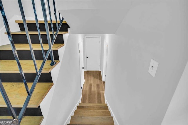 staircase featuring hardwood / wood-style flooring