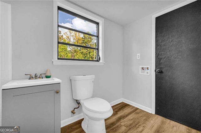 bathroom featuring hardwood / wood-style floors, vanity, and toilet