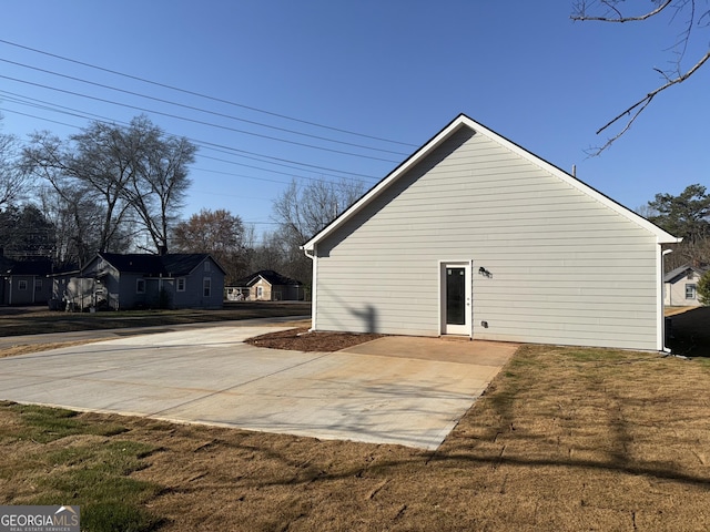 view of side of property with a lawn