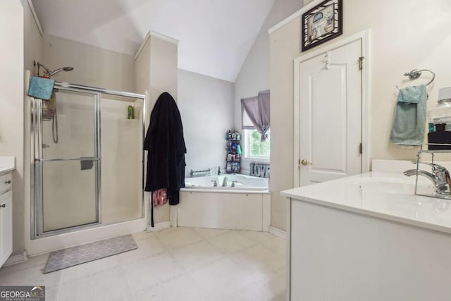 bathroom featuring shower with separate bathtub, vanity, and vaulted ceiling