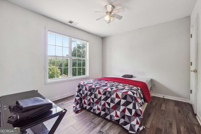 bedroom featuring ceiling fan and dark hardwood / wood-style floors