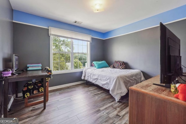 bedroom with hardwood / wood-style flooring