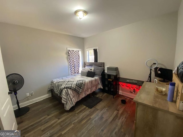 bedroom with dark hardwood / wood-style flooring