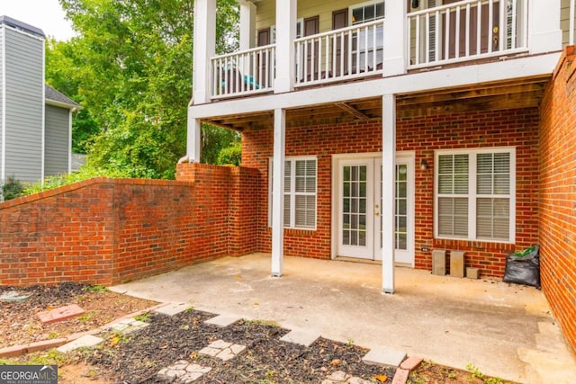 view of patio with a balcony and french doors