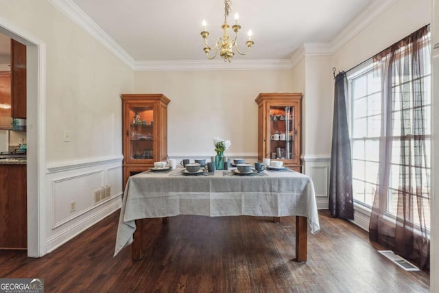 dining area with crown molding, dark hardwood / wood-style flooring, and a chandelier