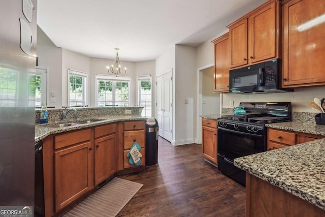 kitchen featuring sink, hanging light fixtures, dark hardwood / wood-style floors, a chandelier, and black appliances