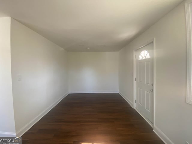 hallway with dark hardwood / wood-style floors