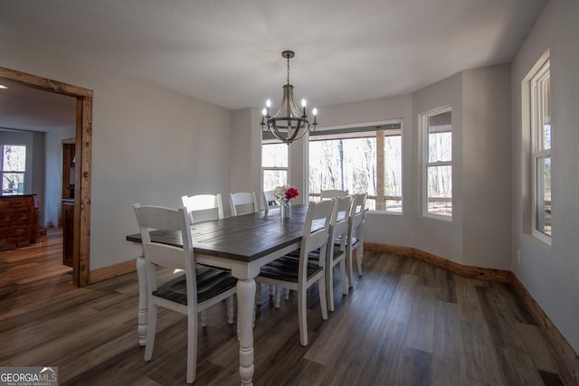 dining space with a chandelier and dark hardwood / wood-style flooring