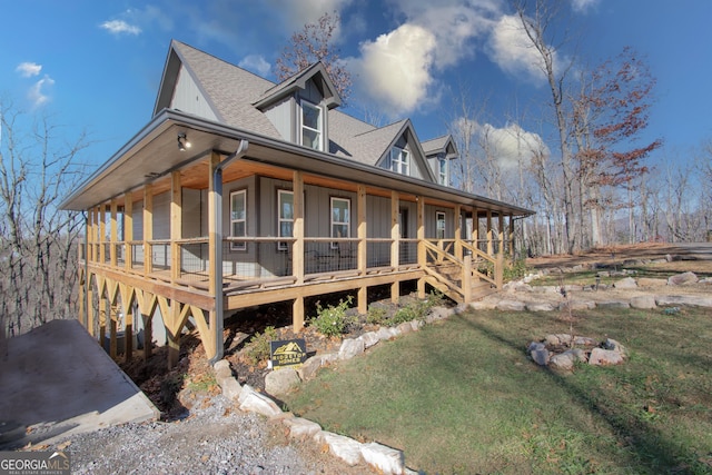 view of side of property with a lawn and a porch