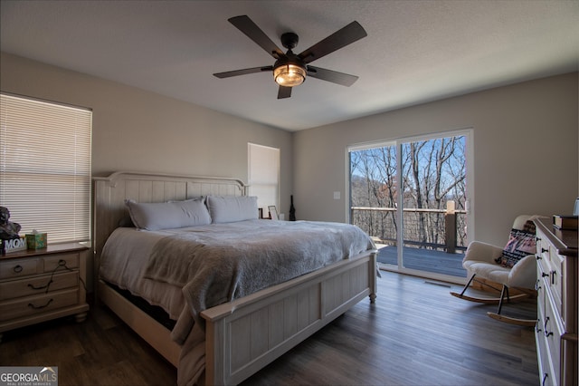 bedroom with ceiling fan, dark hardwood / wood-style floors, and access to exterior