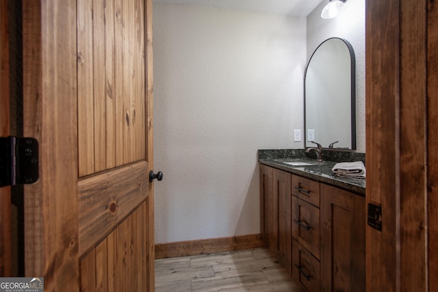 bathroom with hardwood / wood-style floors and vanity