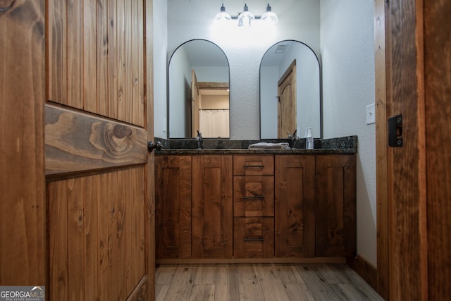 bathroom featuring hardwood / wood-style floors and vanity