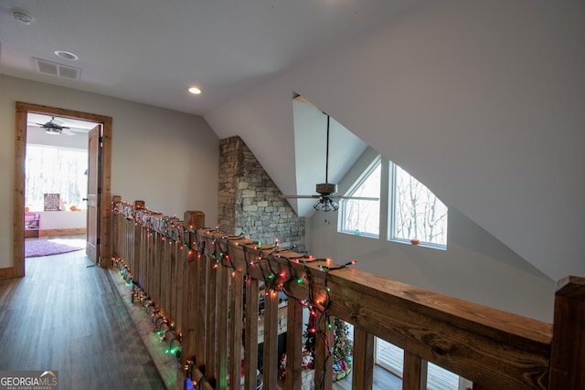 hallway featuring wood-type flooring and vaulted ceiling