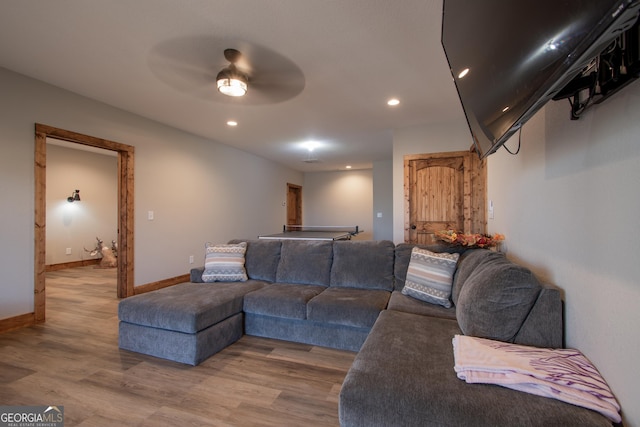 living room with hardwood / wood-style floors and ceiling fan