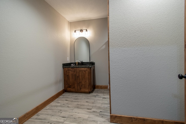 hall with sink and light wood-type flooring