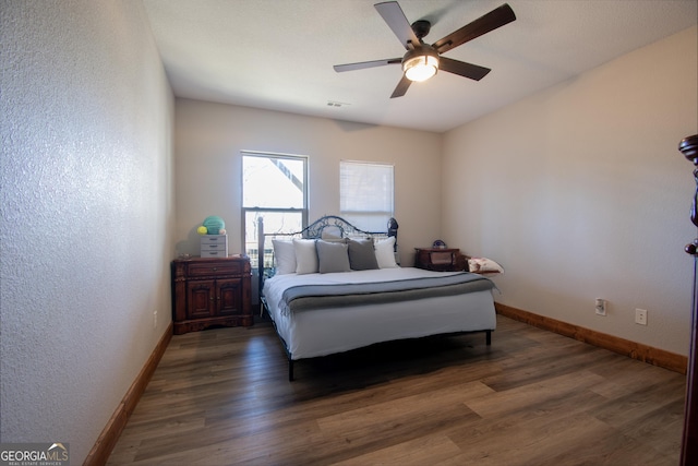 bedroom with ceiling fan and dark hardwood / wood-style flooring