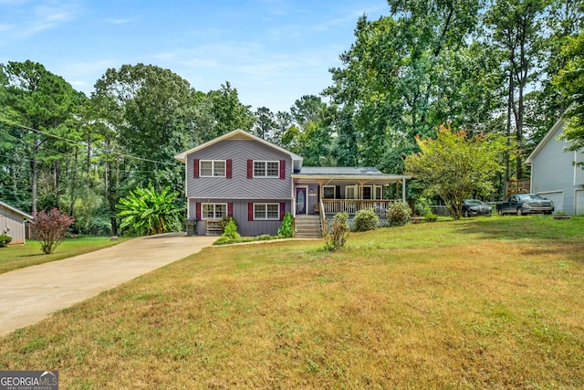 tri-level home with covered porch and a front yard