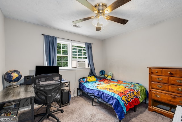 carpeted bedroom with ceiling fan, cooling unit, and a textured ceiling