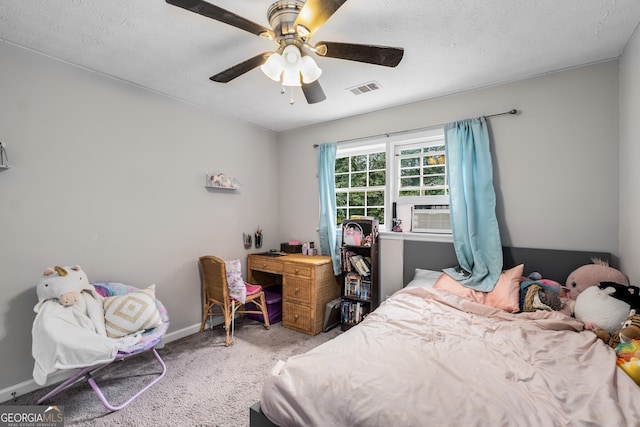 bedroom featuring ceiling fan, cooling unit, light carpet, and a textured ceiling