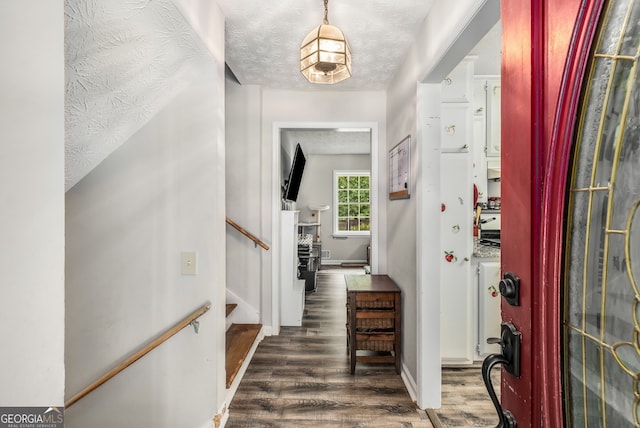 entryway featuring a textured ceiling and dark wood-type flooring