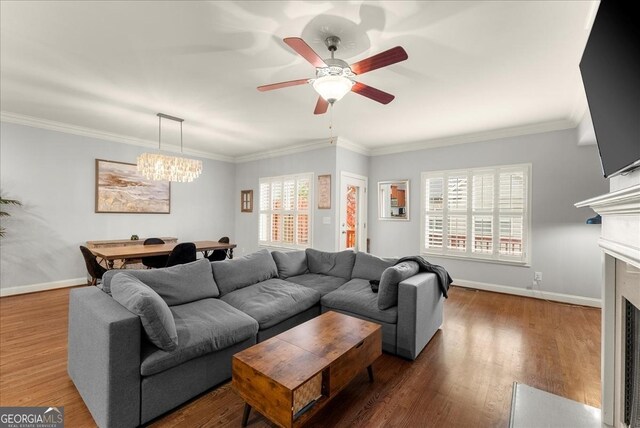 living room with crown molding, ceiling fan with notable chandelier, and dark hardwood / wood-style floors