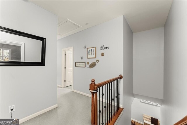 bedroom with connected bathroom, light colored carpet, ceiling fan, and a tray ceiling