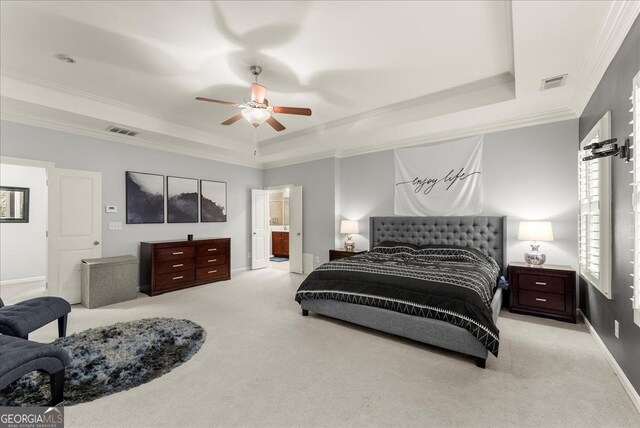 bedroom with ceiling fan, a raised ceiling, light carpet, and crown molding