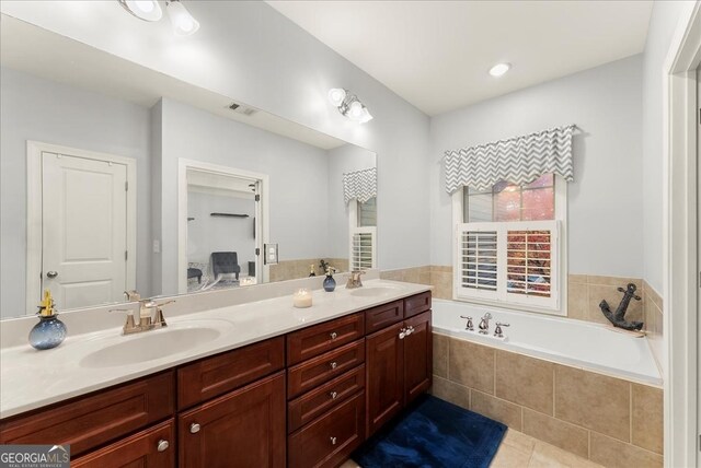 bathroom featuring tile patterned floors, vanity, and plus walk in shower