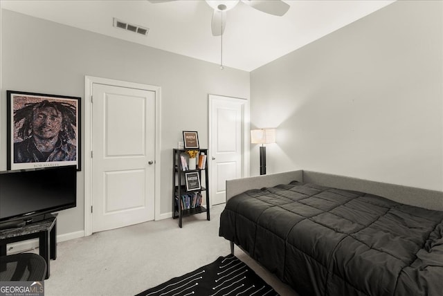 bedroom featuring ceiling fan and light carpet