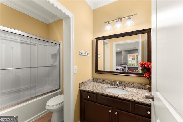 bathroom with toilet, shower / bath combination with glass door, and crown molding