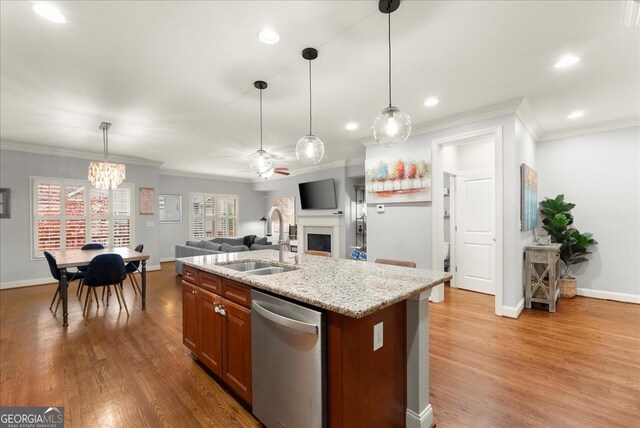 dining area with a wealth of natural light, ornamental molding, ceiling fan with notable chandelier, and hardwood / wood-style flooring