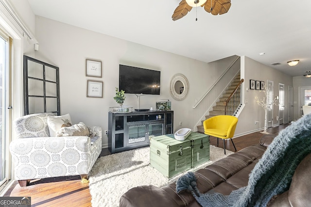 living room featuring ceiling fan and wood-type flooring