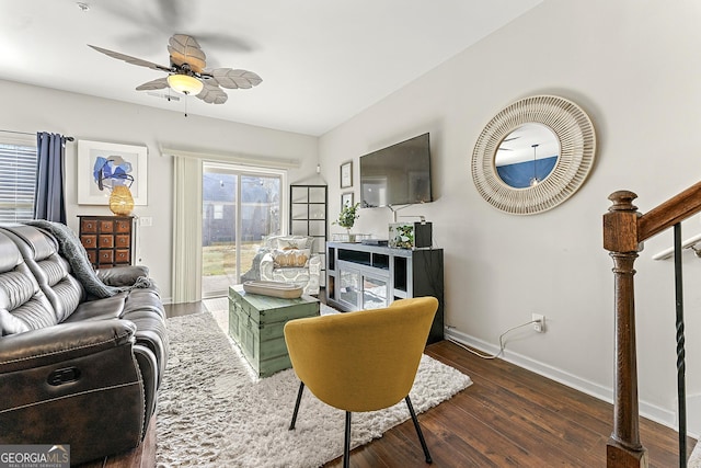 living room with ceiling fan and dark wood-type flooring