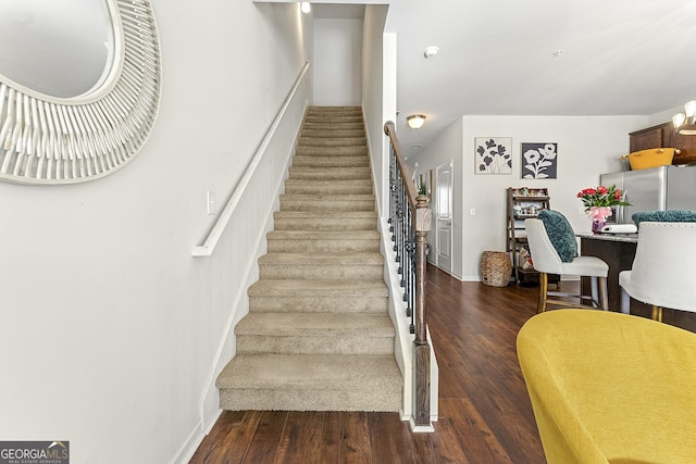 stairway featuring wood-type flooring