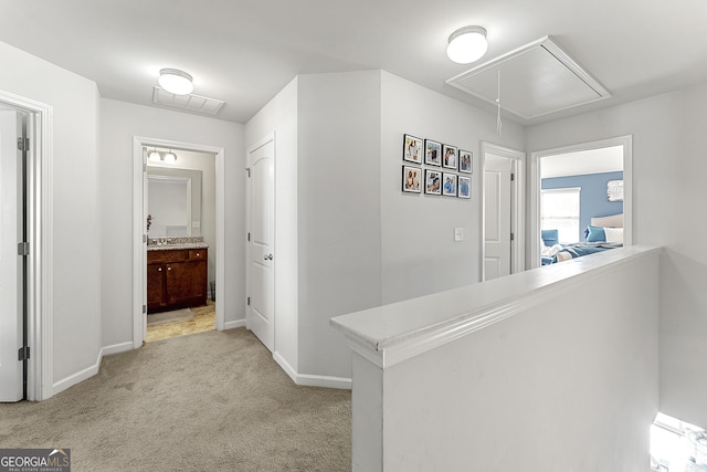 corridor with light colored carpet