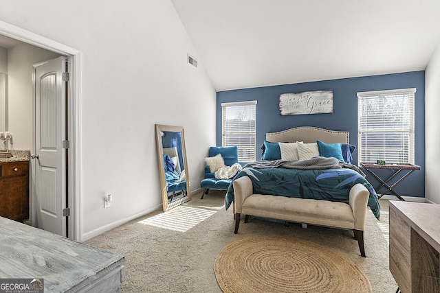 bedroom with multiple windows, light carpet, and vaulted ceiling