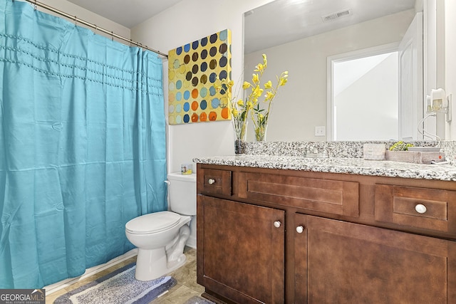 bathroom with tile patterned floors, vanity, toilet, and curtained shower