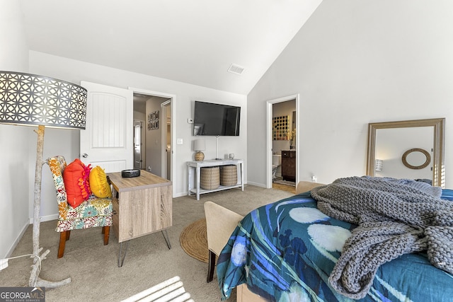 bedroom featuring carpet floors, ensuite bathroom, and high vaulted ceiling